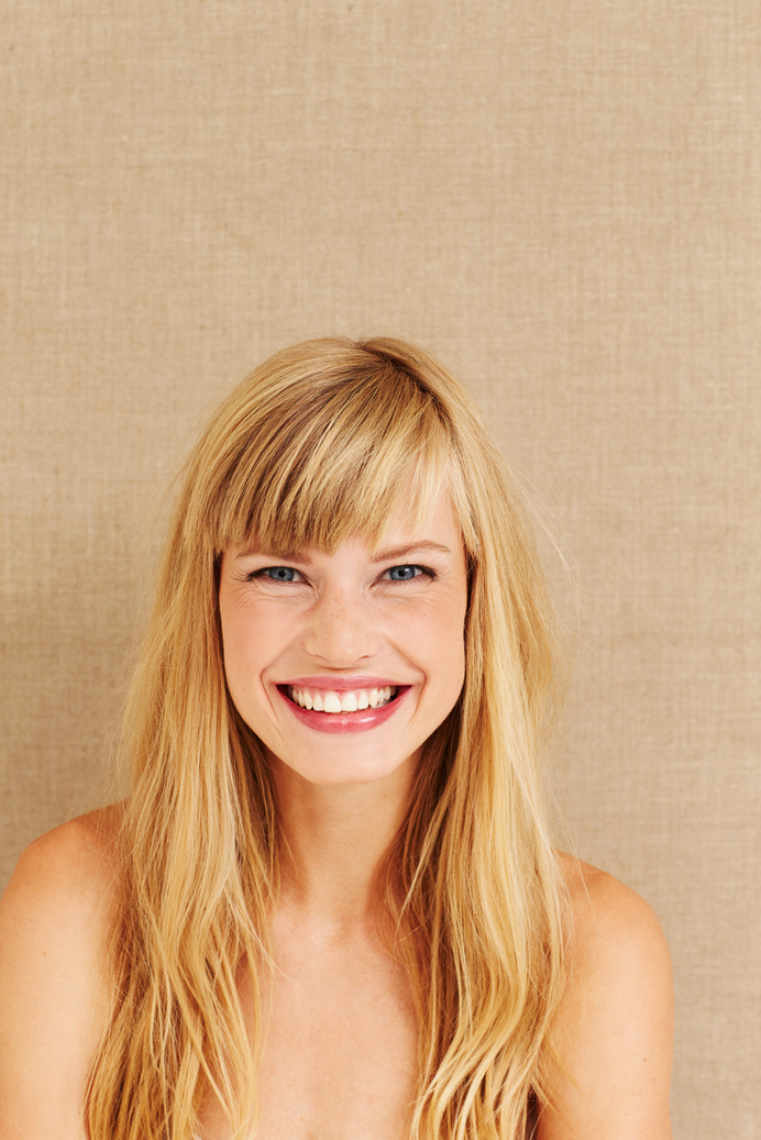 Smiling blond woman in studio